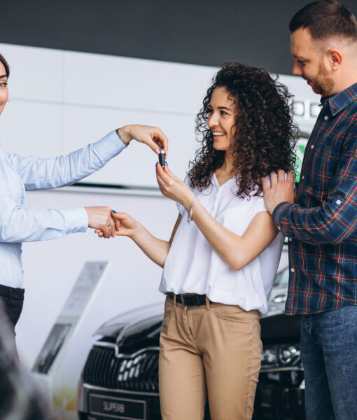 Young couple byuing a car in a car showroom